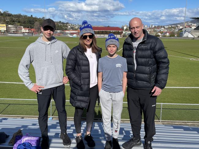 Garry and Melissa Barwick with their sons Benjamin and Campbell at North Hobart Oval. The family are big advocates for Tasmania having its own AFL team.