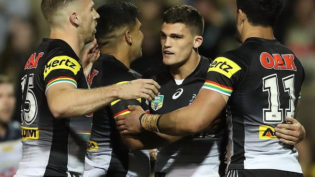 Nathan Cleary is mobbed by Panthers teammates.