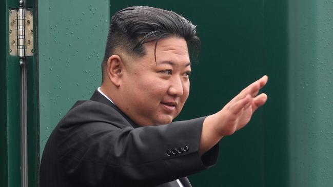 Kim Jong-un waves goodbye from his special train at the Artyom railway station near Vladivostok on Sunday. Picture: Government of Primorye region via AFP