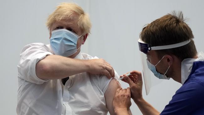 British Prime Minister Boris Johnson receives his second dose of the AstraZeneca coronavirus vaccine from James Black, at the Francis Crick Institute in London.