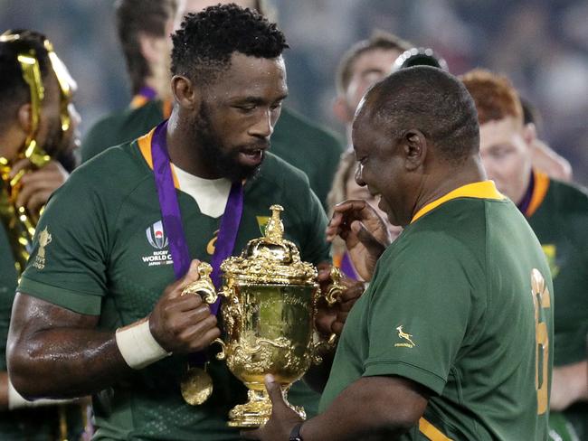 South African captain Siya Kolisi, left, shows the Webb Ellis Cup to South African President Cyril Ramaphosa after defeating England to win the Rugby World Cup final at International Yokohama Stadium in Yokohama, Japan, Saturday, Nov. 2, 2019. (AP Photo/Mark Baker)