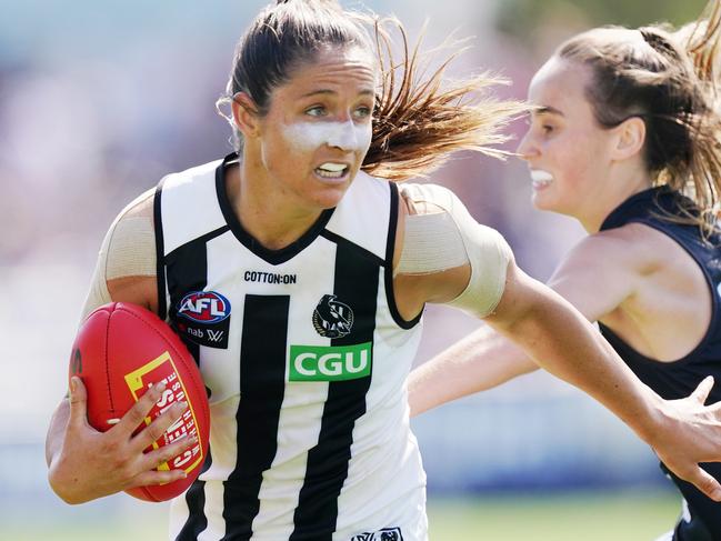 Sophie Alexander of the Magpies runs with the ball from Georgia Gee of the Blues during the Round 2 AFLW match between the Carlton Blues and Collingwood Magpies at Ikon Park in Melbourne, Sunday, February 16, 2020. (AAP Image/Michael Dodge) NO ARCHIVING, EDITORIAL USE ONLY