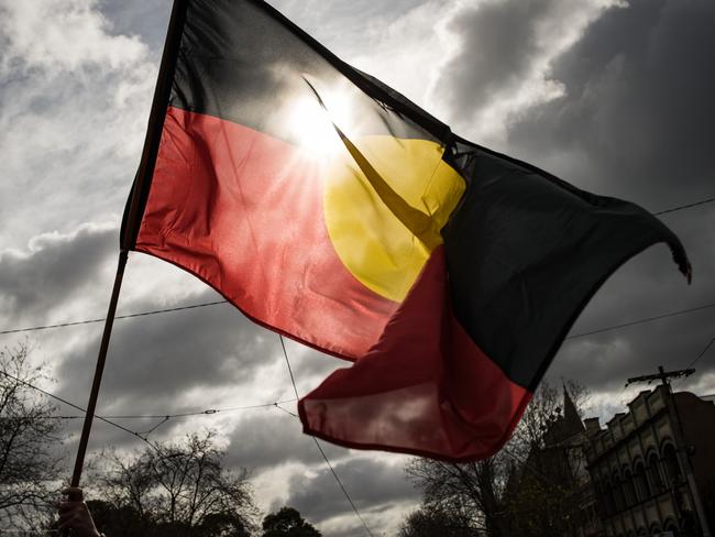 MELBOURNE, AUSTRALIA - JULY 07: The Aboriginal flag is seen flying during the NAIDOC March on July 07, 2023 in Melbourne, Australia. NAIDOC Week is an Australian observance lasting from the first Sunday in July until the following Sunday. The acronym NAIDOC stands for National Aborigines and Islanders Day Observance Committee. The week is intended as a time when all Australians can reflect on the rich history of the country's indigenous peoples, and learn about the cultures and histories of first nations groups. (Photo by Darrian Traynor/Getty Images)