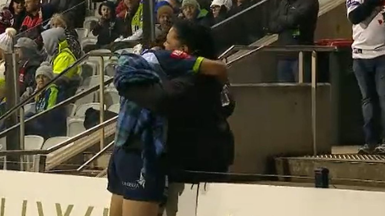 Xavier Savage hugs a family member after being told to leave the field.