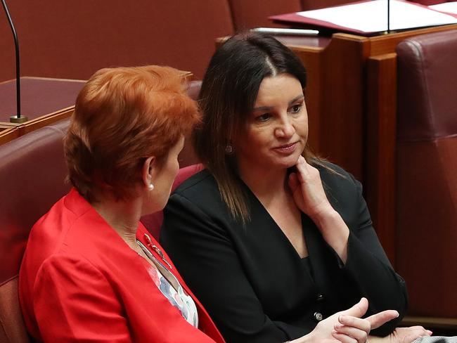 Pauline Hanson talking with Senator Jacqui Lambie at Parliament House in Canberra. Picture: Kym Smith