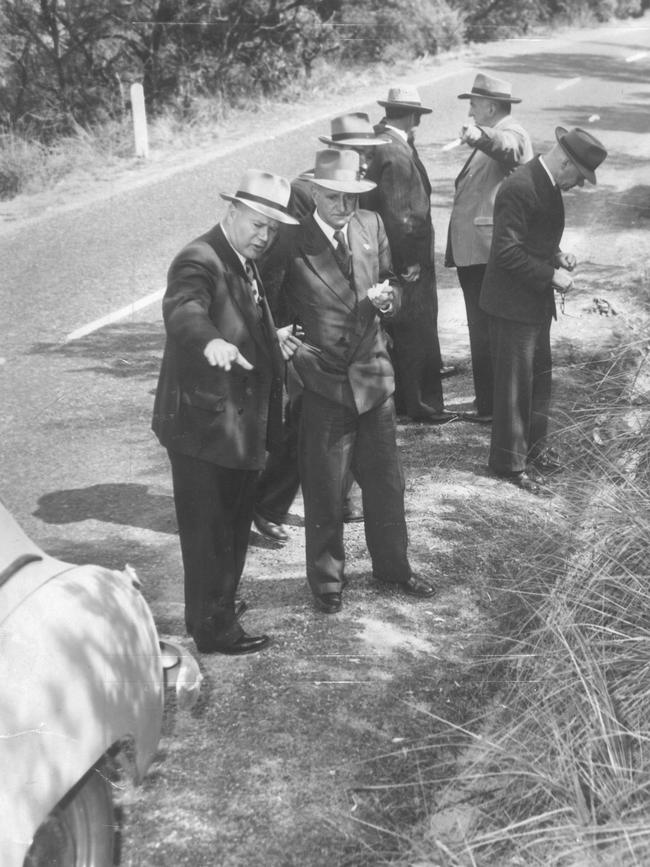 1953: Victorian detectives investigate the murder of 14-year-old Shirley Collins, of Reservoir, at Mt Martha. In the foreground Det Sgt J Matthews is showing fingerprint expert Supt A Martin where the girl fled from her attacker.