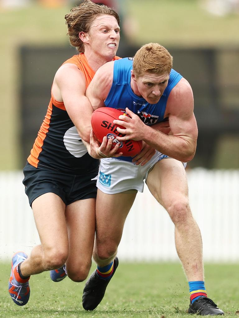 Matt Rowell tackled by Lachie Whitfield on Saturday. Picture: Matt King/Getty Images