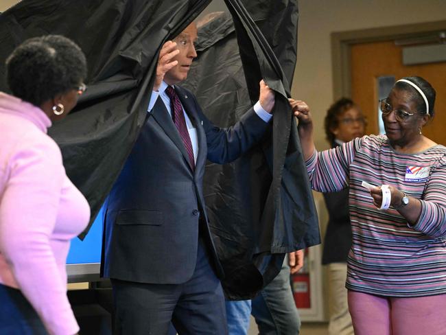 TOPSHOT - US President Joe Biden steps out of the booth after casting his early-voting ballot in the 2024 general election in New Castle, Delaware, on October 28, 2024. (Photo by ANDREW CABALLERO-REYNOLDS / AFP)