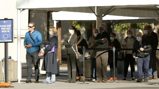 People queue at the mass vaccination hub in Carlton on Wednesday. Picture: Darrian Traynor/Getty Images