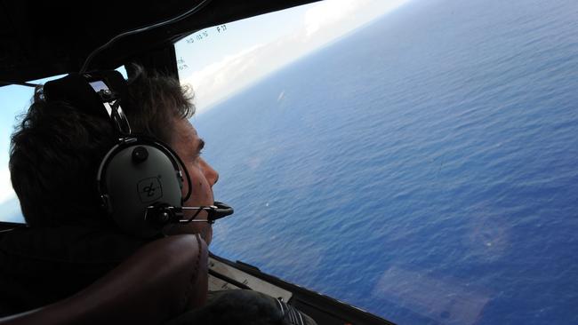 A Royal New Zealand Airforce (RNZAF) P-3K2-Orion aircraft on April 13, 2014 shows co-pilot and Squadron Leader Brett McKenzie helping to look for objects during the search for missing Malaysia Airlines flight MH370, off Perth. Picture: AFP