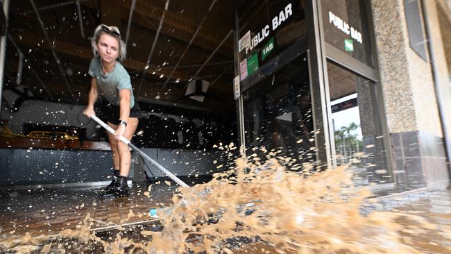 Laani Winkler, 25, helps friend Kylie Gilmore clean her flood ravaged pub, Lismore. Picture: Lyndon Mechielsen