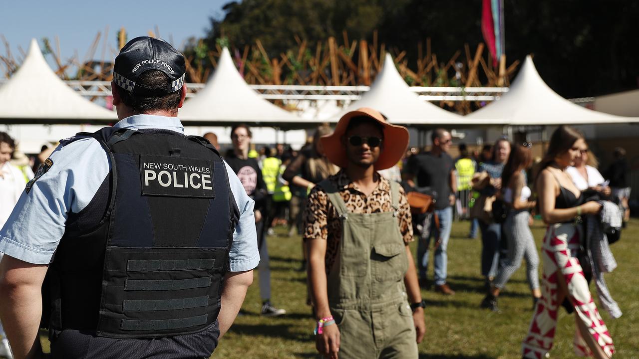 Police officers and drug detection dogs walk amongst festival goers by an entrance to Splendour In The Grass 2019 on July 19 in Byron Bay. (Photo by Mark Metcalfe/Getty Images)