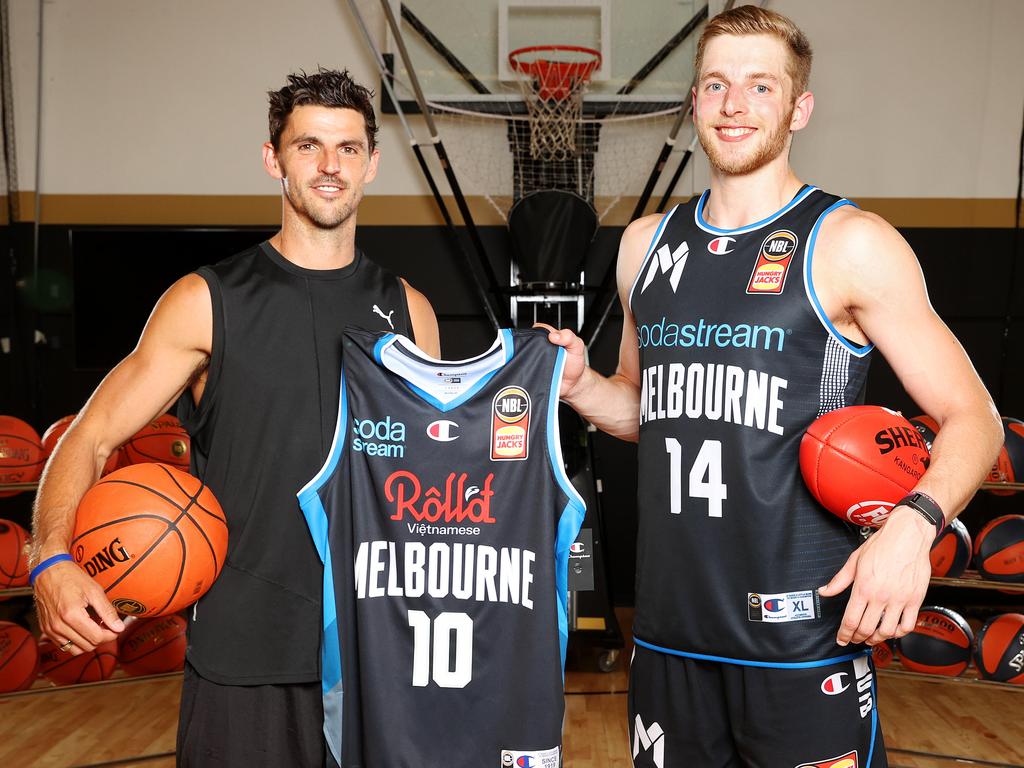 White’s become a bit of a poster boy for United, pictured here with Collinwood AFL captai Scott Pendlebury (yes, Pendles has a basketball background). Picture: Mark Stewart