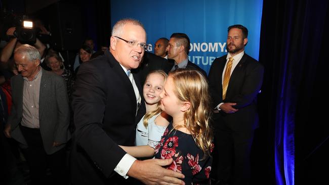 A victorious Prime Minister Scott Morrison hugs his daughters after Bill Shorten conceded. Picture: Hollie Adams