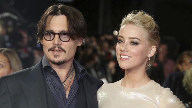 Johnny Depp, left, and Amber Heard, right, arrive at the European premiere of their film, The Rum Diary, in London.