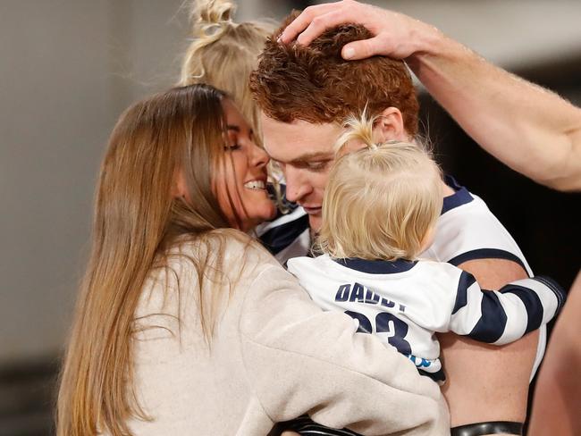 MELBOURNE, AUSTRALIA - MAY 07: Gary Rohan of the Cats and his partner Madi Bennett embrace as he enters the field for his 150th match with his daughters Bella Ray and Sadie Rose during the 2021 AFL Round 08 match between the Richmond Tigers and the Geelong Cats at the Melbourne Cricket Ground on May 07, 2021 in Melbourne, Australia. (Photo by Michael Willson/AFL Photos via Getty Images)