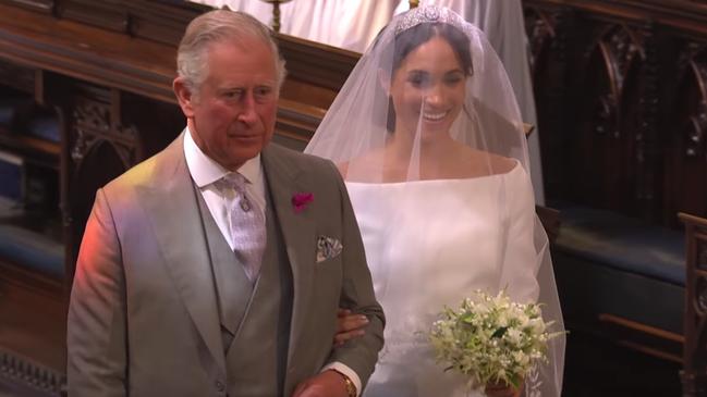 Prince Charles leads Meghan Markle down the aisle of St George’s Chapel during her wedding Prince Harry. Picture: BBC