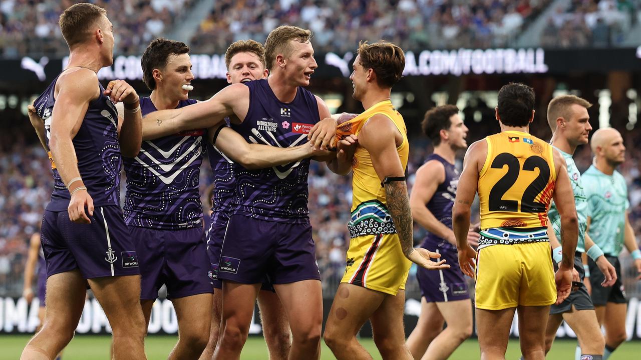 Josh Treacy of the Dockers separates Liam Reidy and Jy Simpkin of the All Stars. Picture: Paul Kane/Getty Images