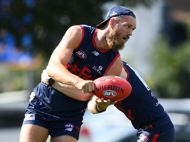 MELBOURNE, AUSTRALIA - MARCH 18: Max Gawn of the Demons handballs whilst being tackled by Clayton Oliver during the Melbourne Football Club media session at AAMI Park on March 18, 2019 in Melbourne, Australia. (Photo by Quinn Rooney/Getty Images)