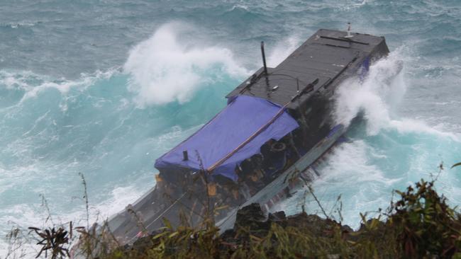 An asylum seeker boat is dashed against rocks off Christmas Island during the 2010 disaster.