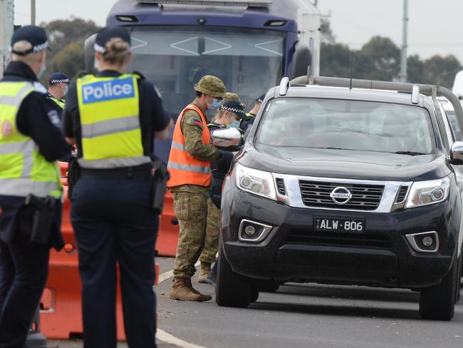 Traffic is banked back at a checkpoint on the Princes Freeway heading out of Melbourne towards Geelong at Little River. Picture: Andrew Henshaw