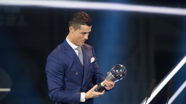 Portugal's Cristiano Ronaldo. who plays for Real Madrid, looks at the trophy after winning The Best FIFA Men's Player award during the The Best FIFA Football Awards 2016 ceremony.