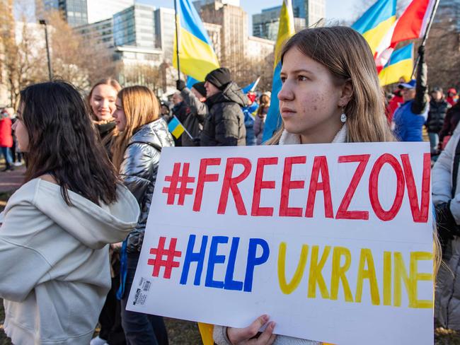People hold signs and flags at a rally to mark the second anniversary of Russia's invasion of Ukraine and ten years since it annexed Crimea at Boston Common in Boston, Massachusetts on February 24, 2024. (Photo by Joseph Prezioso / AFP)