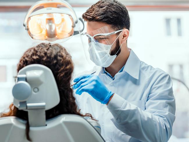 Generic dentist photo  for SAweekendDentist working in dental clinic with patient in the chair.