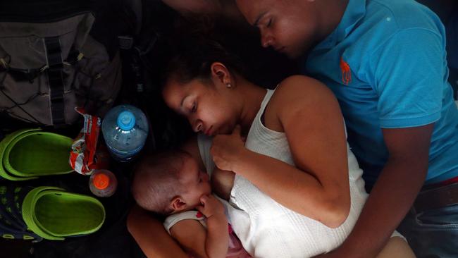 A mother in the migrant caravan feeds her baby while resting at a makeshift camp in Juchitan, Mexico, this week. Picture: Reuters