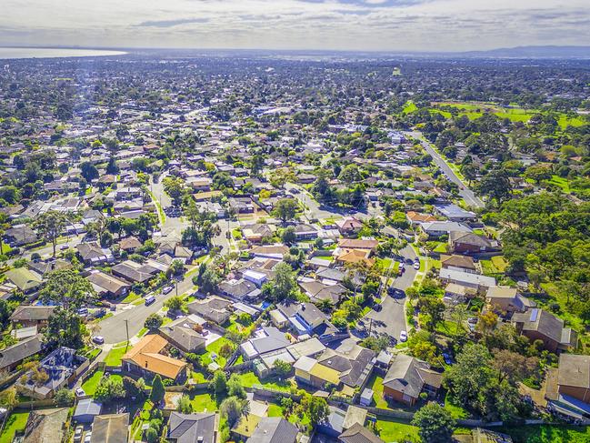 Aerial panorama of town houses near ocean bay on bright sunny day