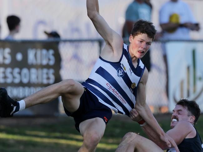 Yarrawonga’s Ben Kennedy is dragged to the ground by Wangaratta’s Jackson Clarke. Picture: Yuri Kouzmin