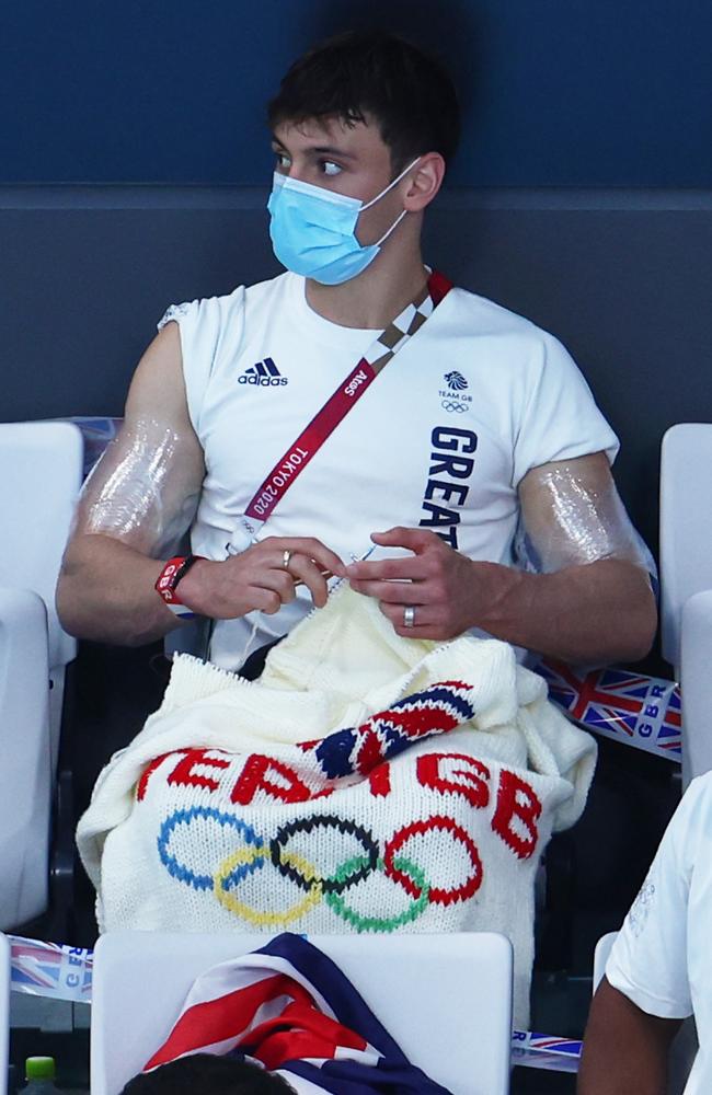 British diver was spotted knitting a Team Great Britain jumper during the Men’s 3m springboard diving preliminary round. Picture: Clive Rose/Getty Images