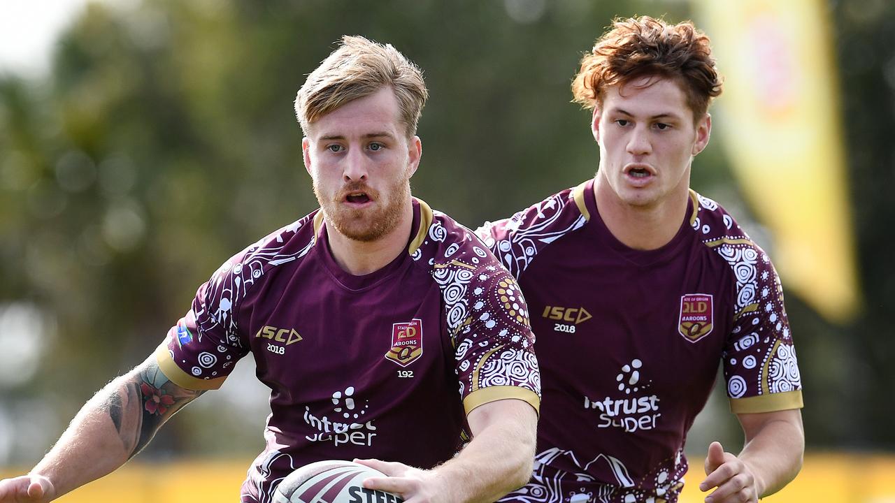 Queensland Maroons coach Kevin Walters wants Cameron Munster (left) to remain in the halves.