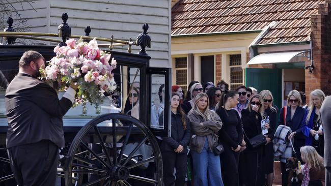 Family and friends gather at the funeral of Brooke Sorlie as her casket arrives by horse and carriage. Picture: Sam Ruttyn