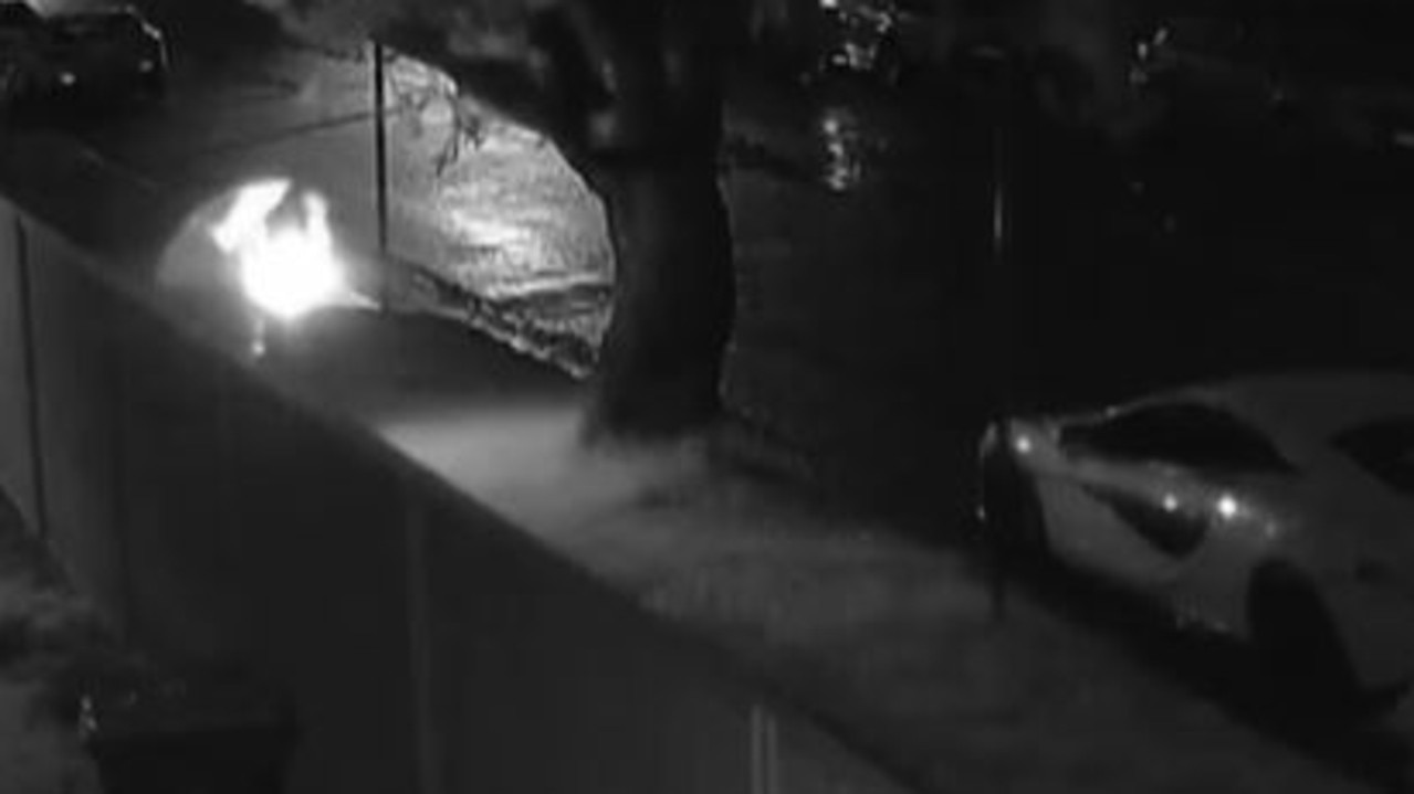 Security footage shows the man lighting the pizza box on fire on the street. Picture: 9News