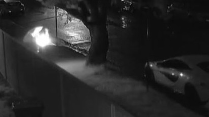 Security footage shows the man lighting the pizza box on fire on the street. Picture: 9News
