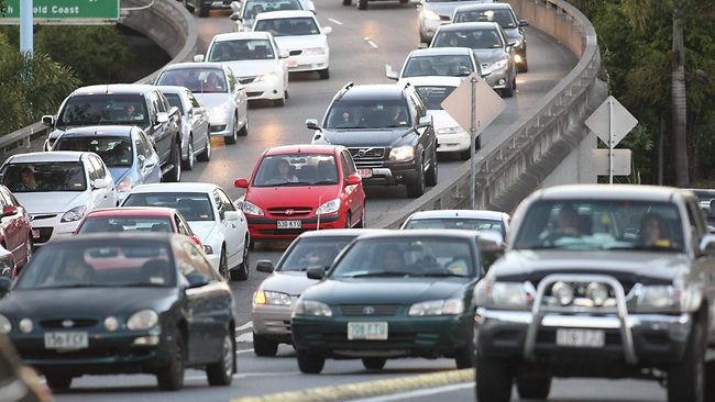 Two trucks and a third vehicle have crashed on the Logan Motorway, causing long delays.