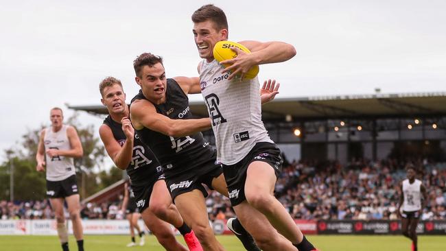 ADELAIDE, AUSTRALIA - FEBRUARY 14: Joe Atley fends off Karl Amon during the Port Adelaide Power Intra-Club match at Alberton Oval on February 14, 2020 in Adelaide, Australia. (Photo by Matt Turner/AFL Photos via Getty Images)