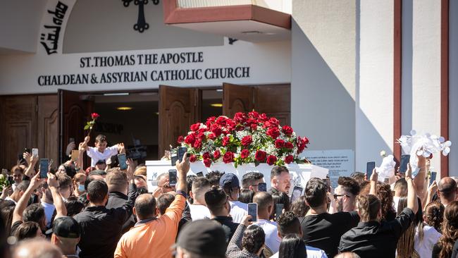 Crowds carry Kettule’s coffin from the church.