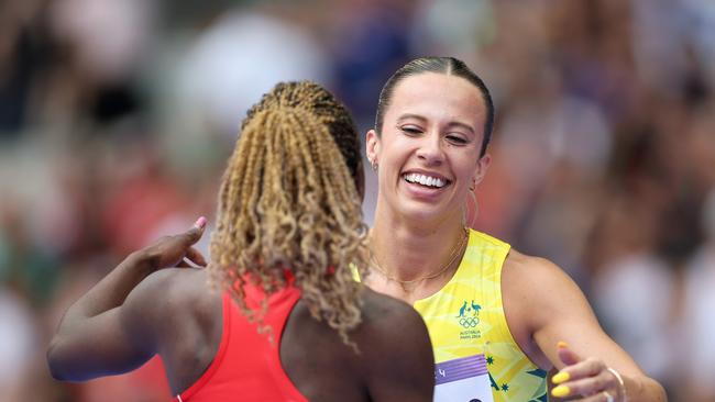 Bree Masters embraces Asimenye Simwaka after the 100m heat. Picture: Michael Steele/Getty Images