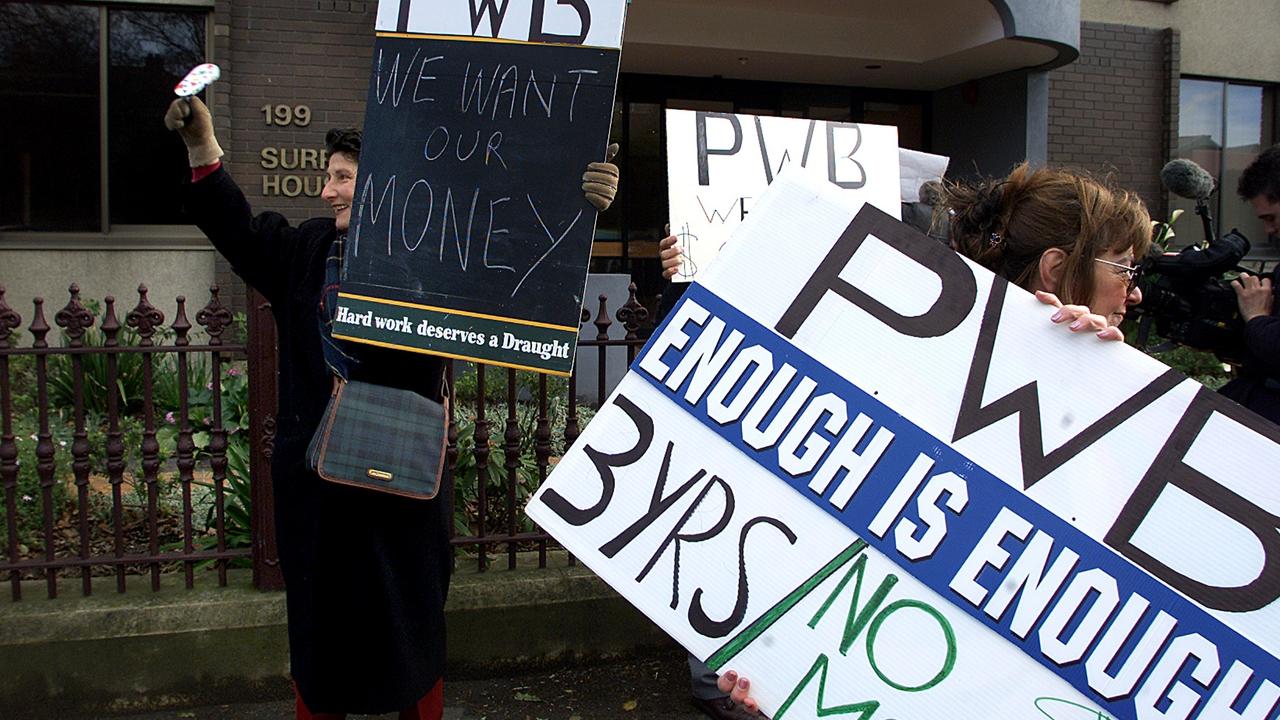 Protesters outside Piggott Wood & Baker in Macquarie Street wave signs at passing motorists. Wendy Stephens makes noise and holds a sign. December 14, 2001. Picture: File