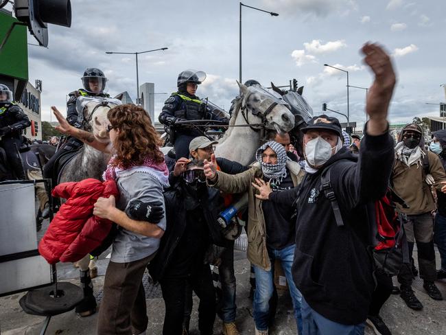 Anti-war activists cash with police on Wednesday. Picture: Jake Nowakowski