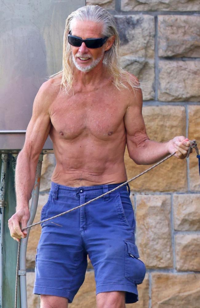 This rarely seen former actor was Serious about hitting the beach for an early morning swim with his dog back in April. Picture: BACKGRID Australia