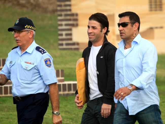 Fadi Ibrahim (centre) and brother Sam are escorted by a guard at the Long Bay Correctional Complex.