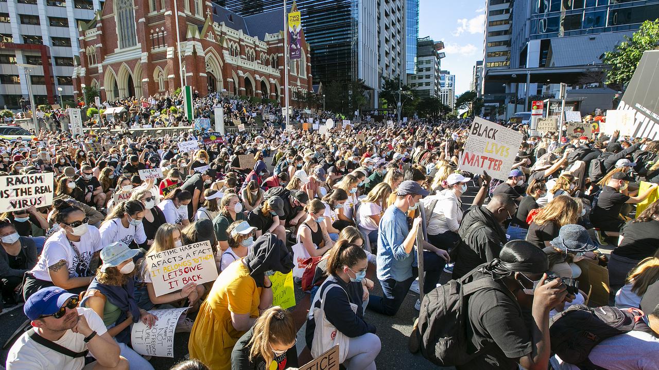 People kneel during the protest at King George Square. Picture: Jono Searle/Getty Images