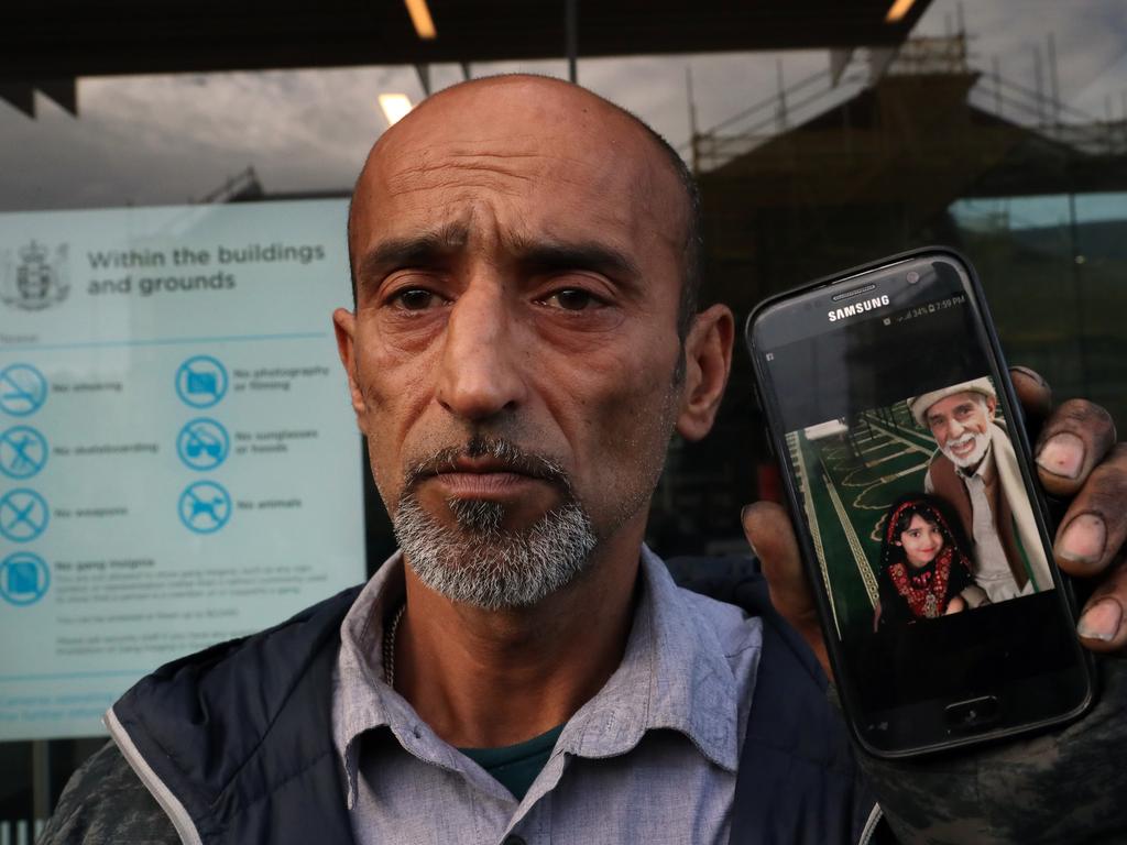 Omar Nabi shows a photo of his dead father Haji Daoud to media at court. Omar said his father’s body is still in the mosque. Picture: Gary Ramage