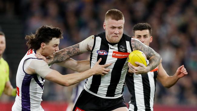 Jordan De Goey shrugs off a tackle. Picture: Dylan Burns/AFL Photos via Getty Images