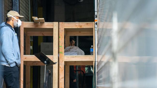 A Bronx-Lebanon Hospital Center employee next to a shelf with a body on April 9.