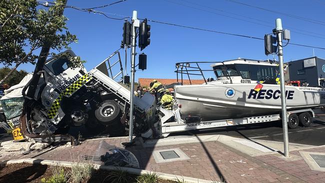 A truck from the SA Sea Rescue Squadron has crashed on Brighton road, with a rescue boat attached to the back.