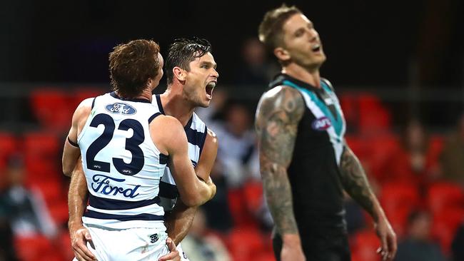 Tom Hawkins and Gary Rohan celebrate during their 60-point win against Port Adelaide.